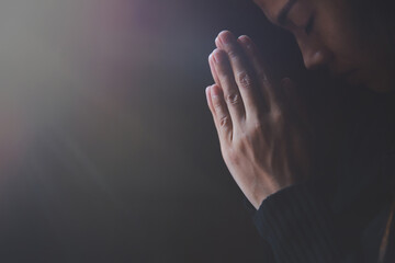  Praying hands with faith in religion and belief in God on dark background. Pay respect.  Namaste...