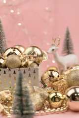 lots of Golden Christmas balls with deer on pink background, New Year background bokeh