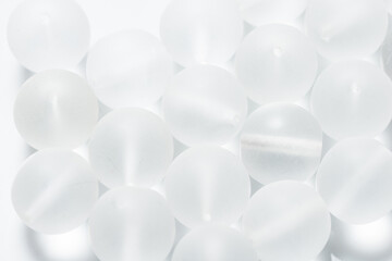 Lot of white matte glass beads and seedbeads, textured background