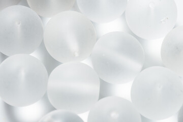 Lot of white matte glass beads and seedbeads, textured background