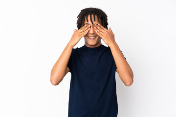 Young african american man isolated on white background covering eyes by hands