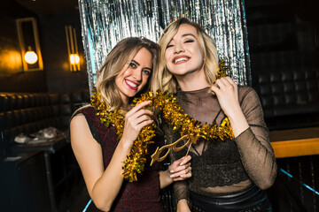 Portrait of happy young female friends together at nightclub