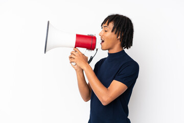 Young african american man isolated on white background shouting through a megaphone