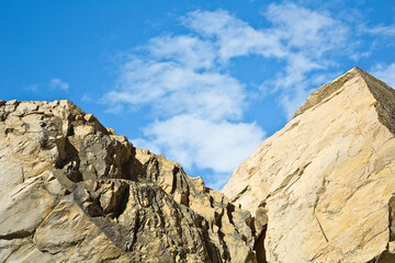 Dam with stone blocks against a blue sky - image with copy space