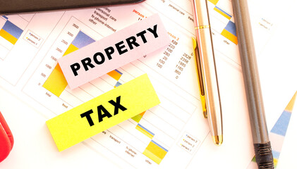 Calculator, pen, notebook, stickers are on the desktop. View from above.