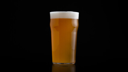 Glass of cold beer with foam in refreshing drinking after working and celebration concept