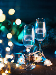 Two glasses of champagne on a dark Christmas background. Celebrate new year