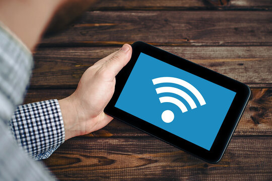 Wifi network. Wireless internet connection. Tablet mobile spot. Online symbol background. Wi-fi icon. Modern computer technology. Mobile device network signal. Hand holding tablet.
