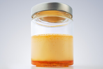 Cream caramel in a jar isolated on white background