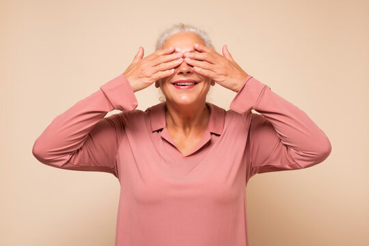 Woman Closing Her Eyes With Hands Going To See Surprise Prepared By Her Family Waiting For A Gift.