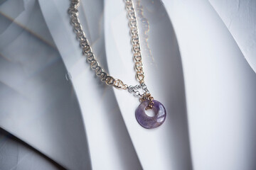 Gold chain necklace and charoite ring pendants