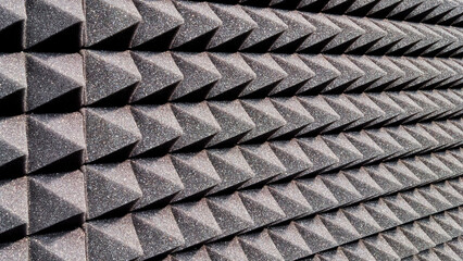 Background image of recording studio sound dampening acoustical foam.