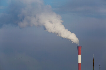 Smoke rises from a industrial chimney during a foggy morning in the city of Belgrade, Serbia.