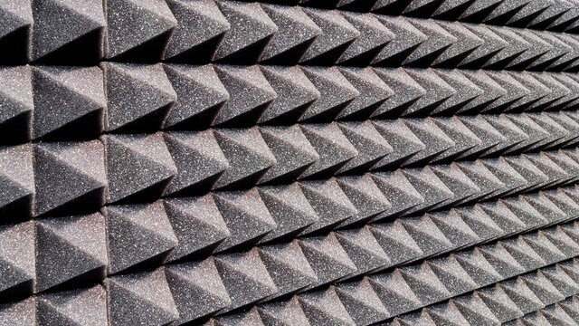 Background image of recording studio sound dampening acoustical foam.