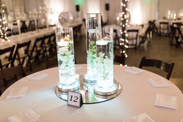 candles and flowers on banquet event tables for centerpieces