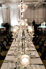 candles and flowers on banquet event tables for centerpieces