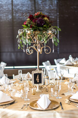 candles and flowers on banquet event tables for centerpieces