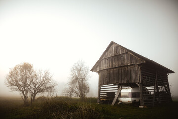 Lonely barn in the evening mist