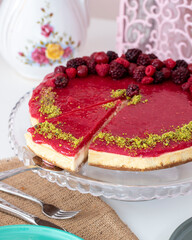 Cheesecake with berries on white wood - homemade cake
