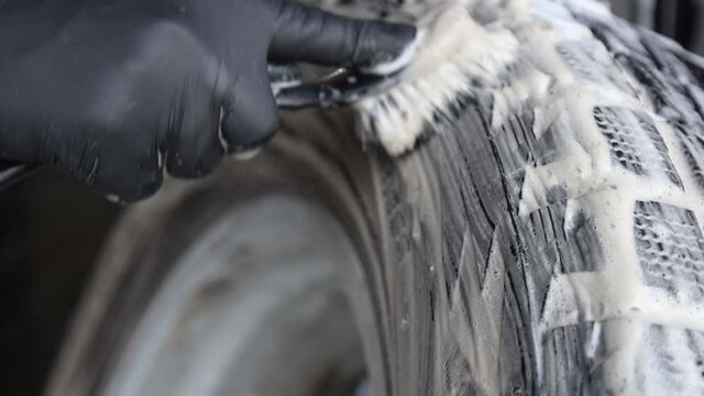 Male worker wash the car. Cleaning Car Using High Pressure Water.