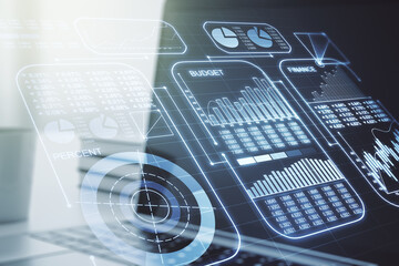 Multi exposure of creative statistics data hologram on laptop background, stats and analytics concept