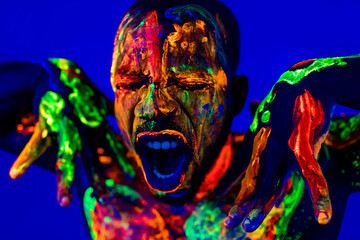 afro american man with UV body art posing in studio