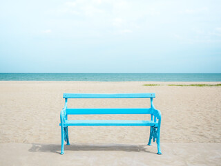 Fototapeta na wymiar Empty blue wooden bench on the beach.
