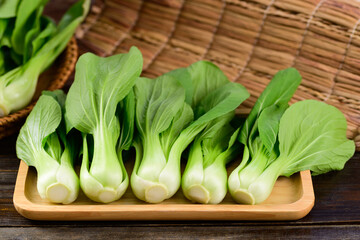 Fresh Bok Choy or Pak Choi (Chinese cabbage) on wooden tray, Organic vegetables