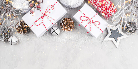 Festive Christmas background with white gift boxes and Christmas decorations.