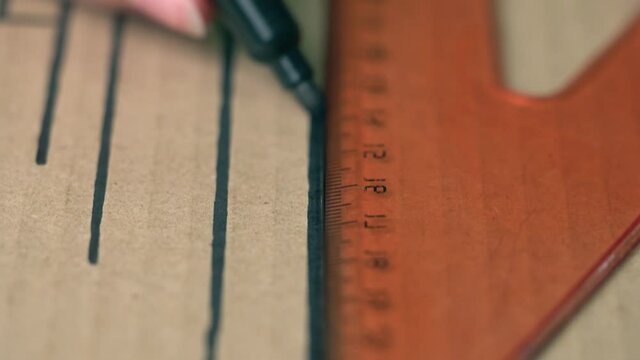 The person draws a line parallel to the other lines