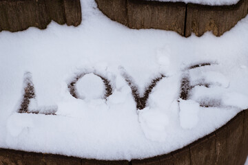 The word love is written on the snow
