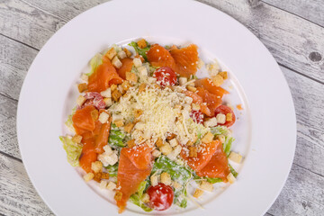 Caesar salad with salmon and parmesan