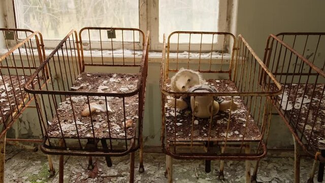 Baby cots in an abandoned kindergarten in the ghost town Pripyat in the Chernobyl exclusion zone in Ukraine 2020