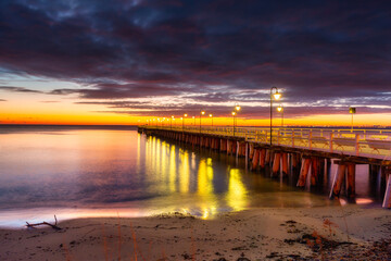 Fototapeta premium Beautiful landscape with wooden pier in Gdynia Orlowo before sunrise, Poland