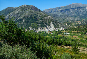 Summer landscape -Albanian mountains, covered with green trees and blue sky.