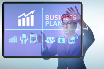 Business plan concept with businessman pressing button