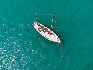 Fototapeta premium Amazing sail boat is sailing across the deep blue sea. Top view.
