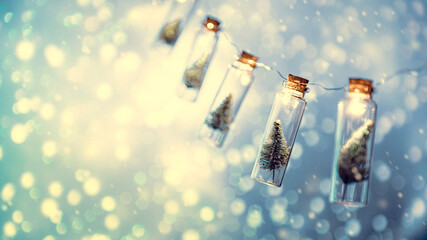 Close-up, Elegant Christmas tree in glass jar with bokeh lights background, copy space. Christmas...