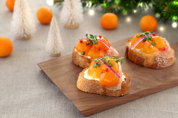 Delicious open sandwich tartine with kumquat compote, prosciutto and cream cheese. Holiday...