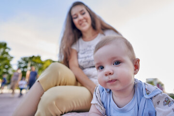 Cute baby with mom on a walk.Close-up