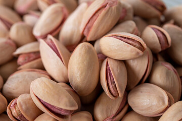 pistachios in bowl - on wooden background - close up