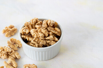 walnuts in bowl - on wooden background