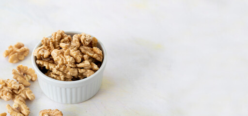 walnuts in bowl - on wooden background - copy space