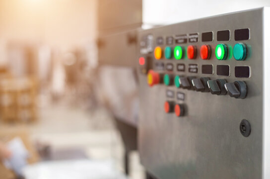 Control panel with multi-colored buttons to control production equipment and production line, copy space for texr
