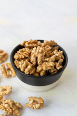 walnuts in bowl - on wooden background
