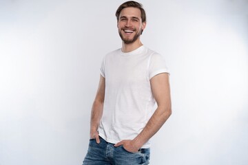 Fototapeta premium Sexy smiling handsome man in white t-shirt isolated on white.