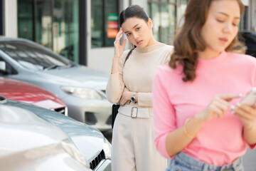 Two women at car accident site.