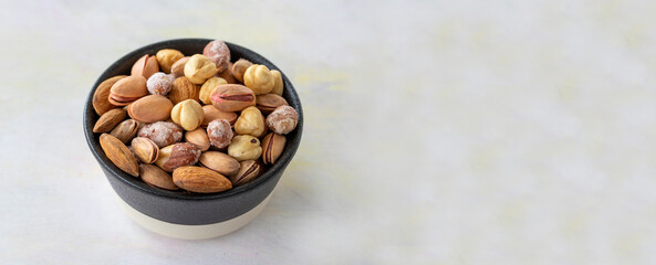 mixed nuts in bowl - on white background - copy space