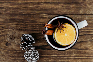 Christmas and New Year's drink hot wine, mulled wine, punch or tea on a wooden background with place for text.