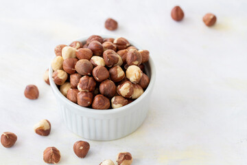 Hazelnuts in plate on white background
